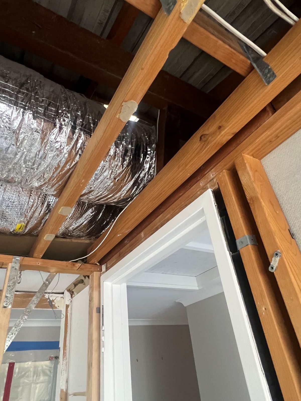 Timber ceiling framing and ducting inspected above a doorway at Hallett Cove