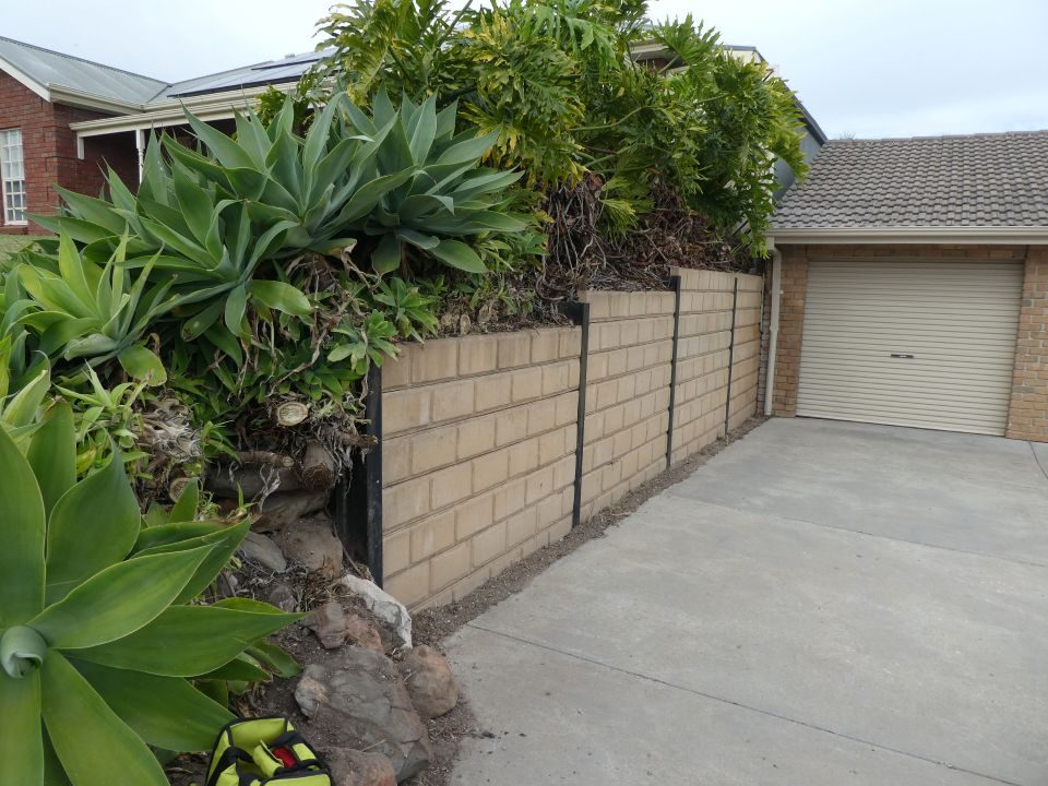 Brick retaining wall beside a driveway during an inspection at Hallett Cove