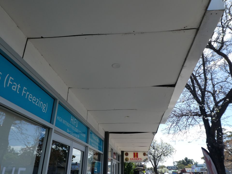 Shop-front verandah soffit inspected for movement at Kilburn