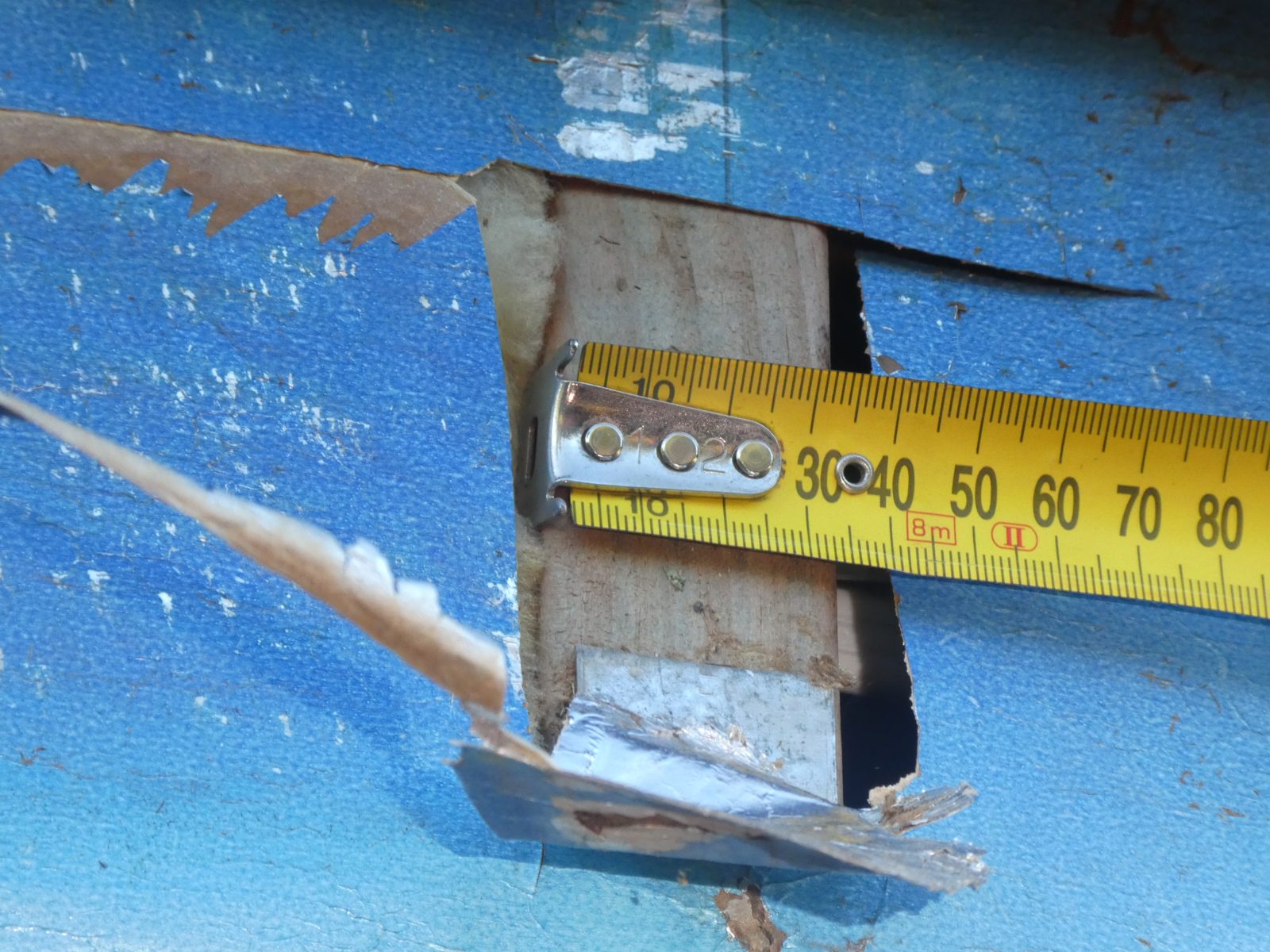 Close measurement of a timber stud behind cladding at Meadows