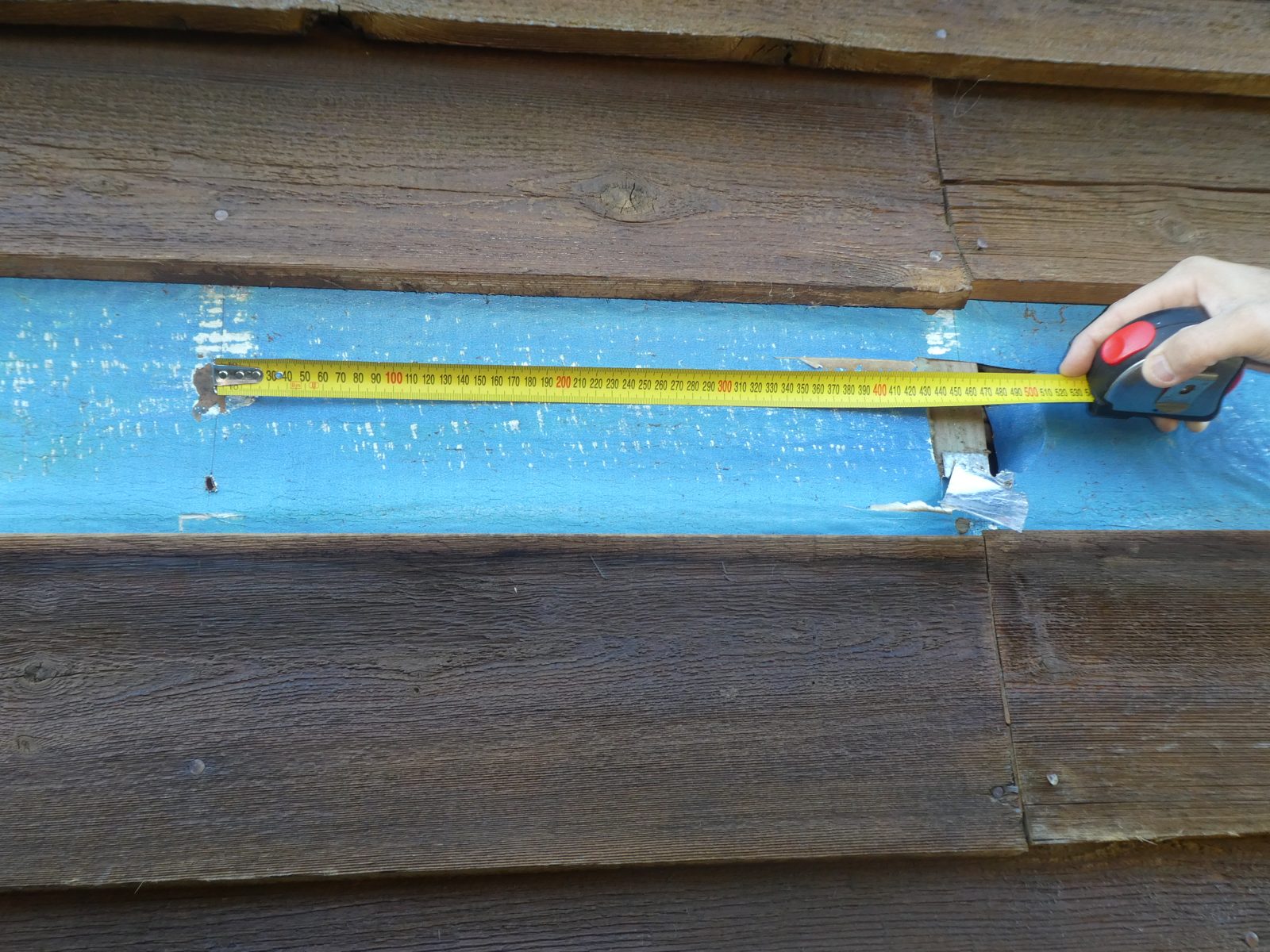Tape measure across timber cladding and studs at Meadows