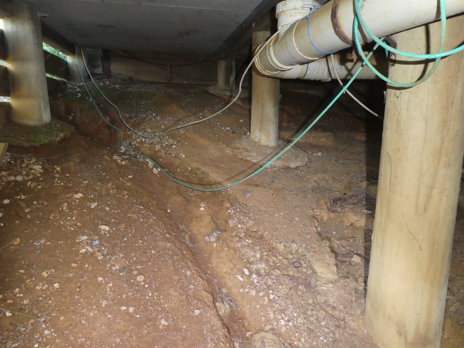 Subfloor piers, soil and services during a timber framing inspection at Meadows