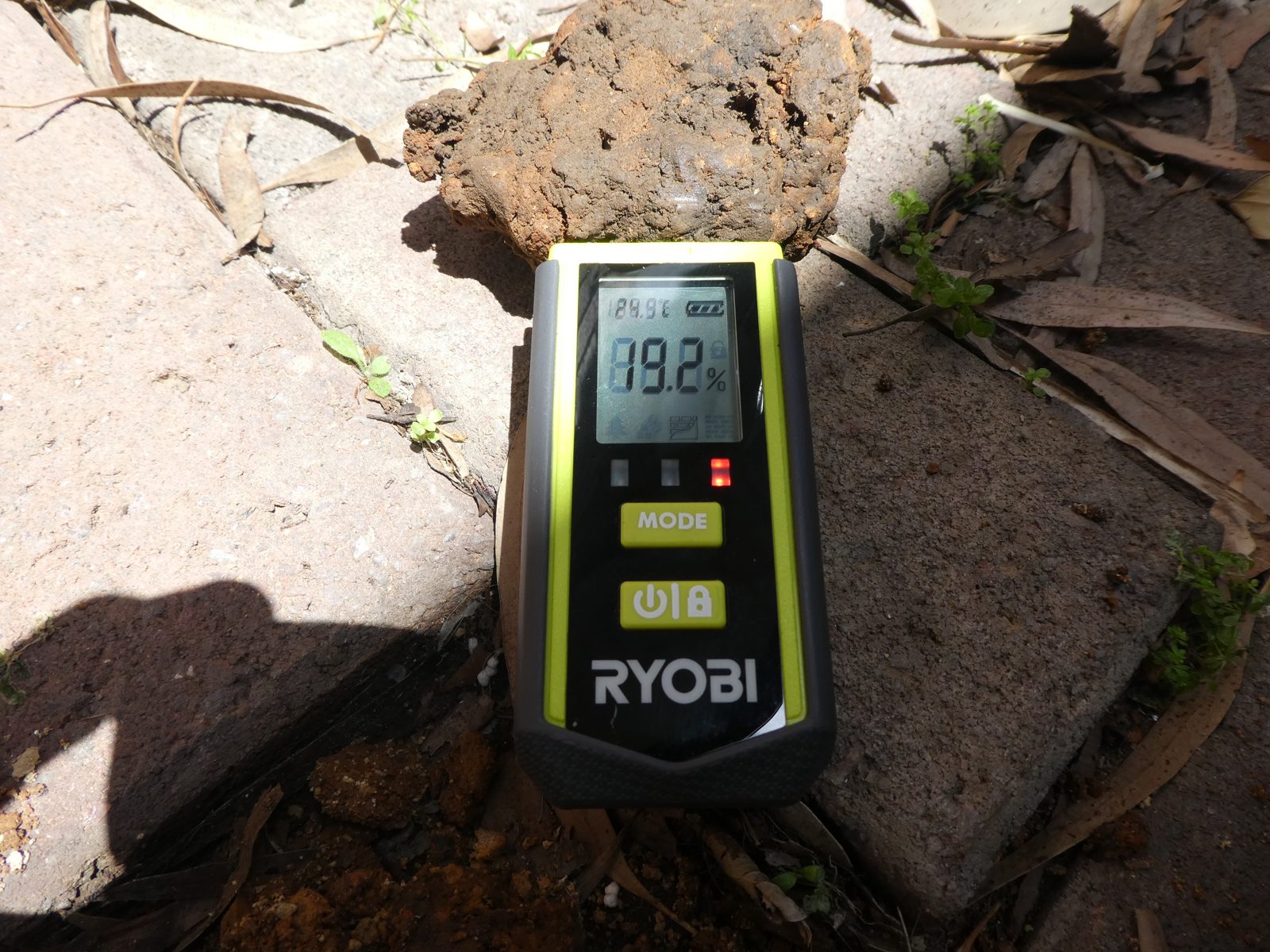 Handheld moisture meter reading of a soil sample on site
